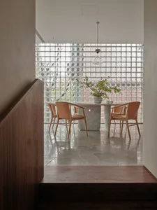 A modern dining room with white marble table and chairs.