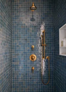 A modern minimalist bathroom with dark blue tiles and brass fixtures.