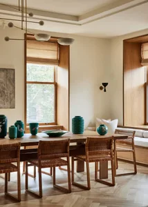 A minimalist interior design with wooden furniture, large windows, and green vases.