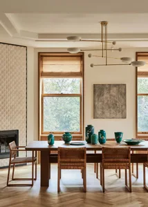 Modern dining room featuring wooden furniture, large windows, and contemporary lighting.