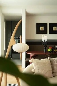 Modern living room featuring wood, fabric, and metal elements.