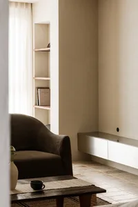 A minimalist living room featuring contemporary furniture and simple decor.