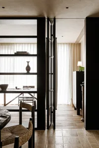 A minimalist residential interior featuring wooden elements and natural light.