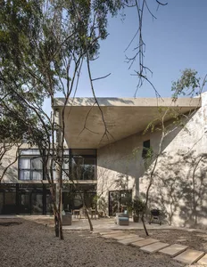 Modern house with a concrete exterior and a courtyard.