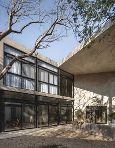 The exterior of a modern building featuring concrete and glass materials.