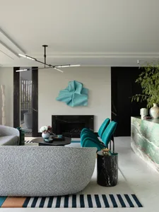 A modern living room featuring marble elements and contemporary furniture.