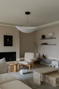 A modern living room with a marble and concrete interior design.