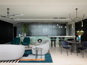 A modern living room with sleek marble finishes and contemporary furniture.