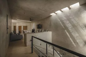 Interior design featuring minimalist living area with concrete walls and flooring