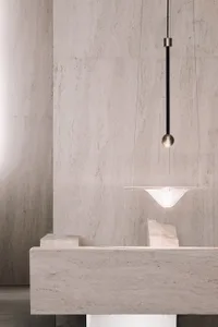 Minimalist modern contemporary bar interior with light fixture and marble countertop.
