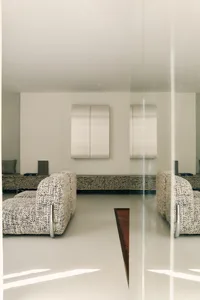 Minimalist living room with neutral furnishings and a minimalist aesthetic.
