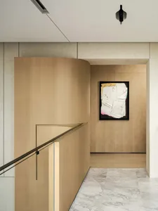 Modern interior design featuring wooden panels and marble wall