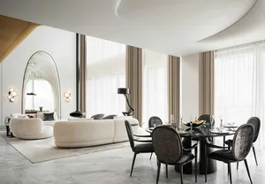 A modern, luxurious living and dining room featuring marble finishes and elegant decor.