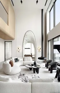 Modern living room featuring a white marble curtain, a sleek white sofa adorned with modern cushions, and a stylish black cof