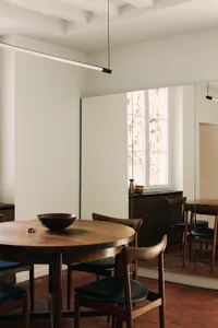 Modern minimalist kitchen featuring wooden furniture and a simple, clean design.