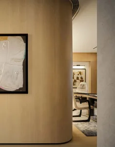 Modern office space featuring wooden paneling with an abstract painting and ergonomic furniture.