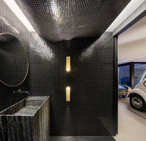 Modern bathroom with black metallic tiles and a minimalist design.