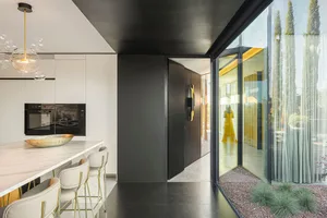Modern kitchen with glass walls and marble countertop