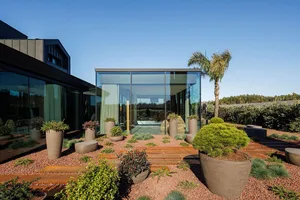 Contemporary residential exterior featuring large glass panels.