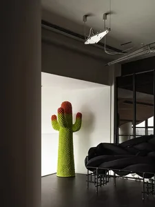 A living room with metallic furniture and a cactus sculpture.