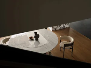 Minimalist dining room with marble table top and walnut chairs, featuring a vase and bowl centerpiece.