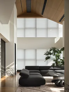 Modern minimalist living room featuring wooden walls, marble floor, and fabric furniture.