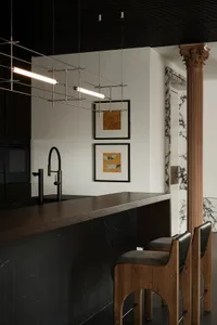 A modern kitchen with a dark marble countertop and minimalist design.