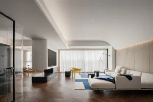 Modern living room featuring a minimalist design with wood composite board flooring, a white sofa, and a yellow armchair.