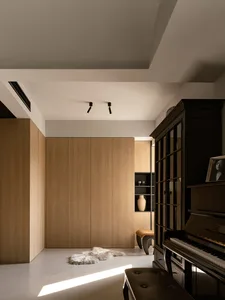 A modern music room featuring wood-paneled walls, a grand piano, and a cozy atmosphere.