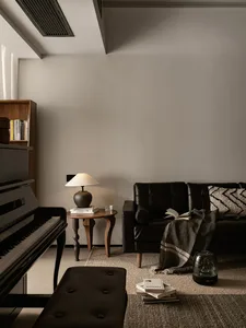 A modern, black profile couch in a living room setting.