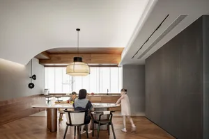 A modern residential kitchen featuring wooden surfaces and marble countertops.