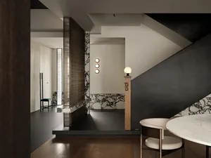 Modern interior living space with marble and concrete materials.
