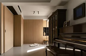 Modern, minimalist living room with wooden furniture and floor-to-ceiling cabinets.