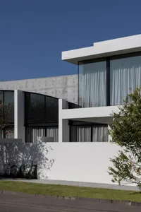 A modern residential home with concrete and glass exterior.