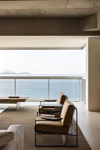 Modern interior living room with concrete, glass, and wooden elements.