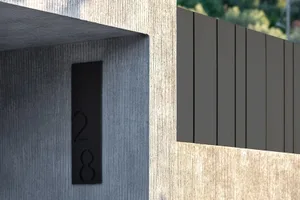 Modern entrance featuring a textured concrete wall and horizontal wooden panels.