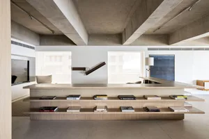 Modern living room featuring concrete, wood, and glass materials