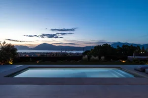 A modern residential exterior with concrete finish.