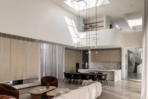 Modern open-plan living room featuring minimalist design, neutral color palette, and natural light
