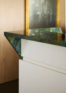 Close-up of a modern interior featuring a marble chair, highlighting the material and design.