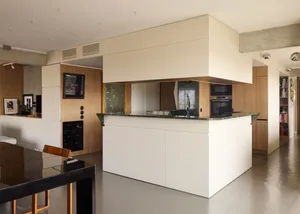 A modern residential kitchen with granite countertops and minimalist design.