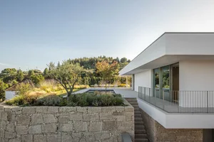 Modern villa featuring stone walls, concrete floor, and glass windows.