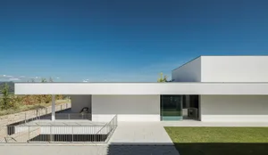 Modern residential house featuring minimalist design and concrete exterior.