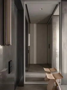 Modern interior space featuring a minimalist design with a textured concrete floor.