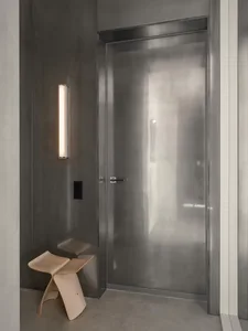 Modern entrance with a metal door and minimalist design