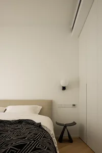 Cushioned headboard and wooden floor in minimalist bedroom setting