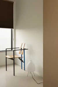 A minimalist room with wooden elements and a large window.