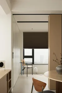 Modern minimalist living room featuring wooden furniture, a large window with blinds, and a sleek design.