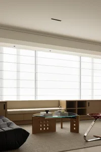 A modern, minimalist living room with a white sofa, wooden furniture, and neutral-toned decor.