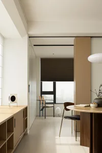 A modern interior design featuring wooden furniture, glass elements, and metal accents.